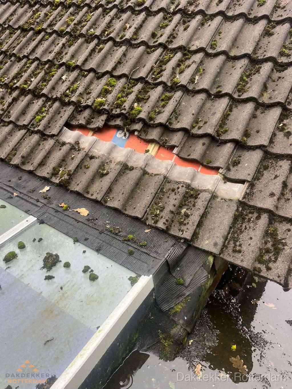 Beschadigd pannendak met ontbrekende dakpannen voor reparatie in Rotterdam